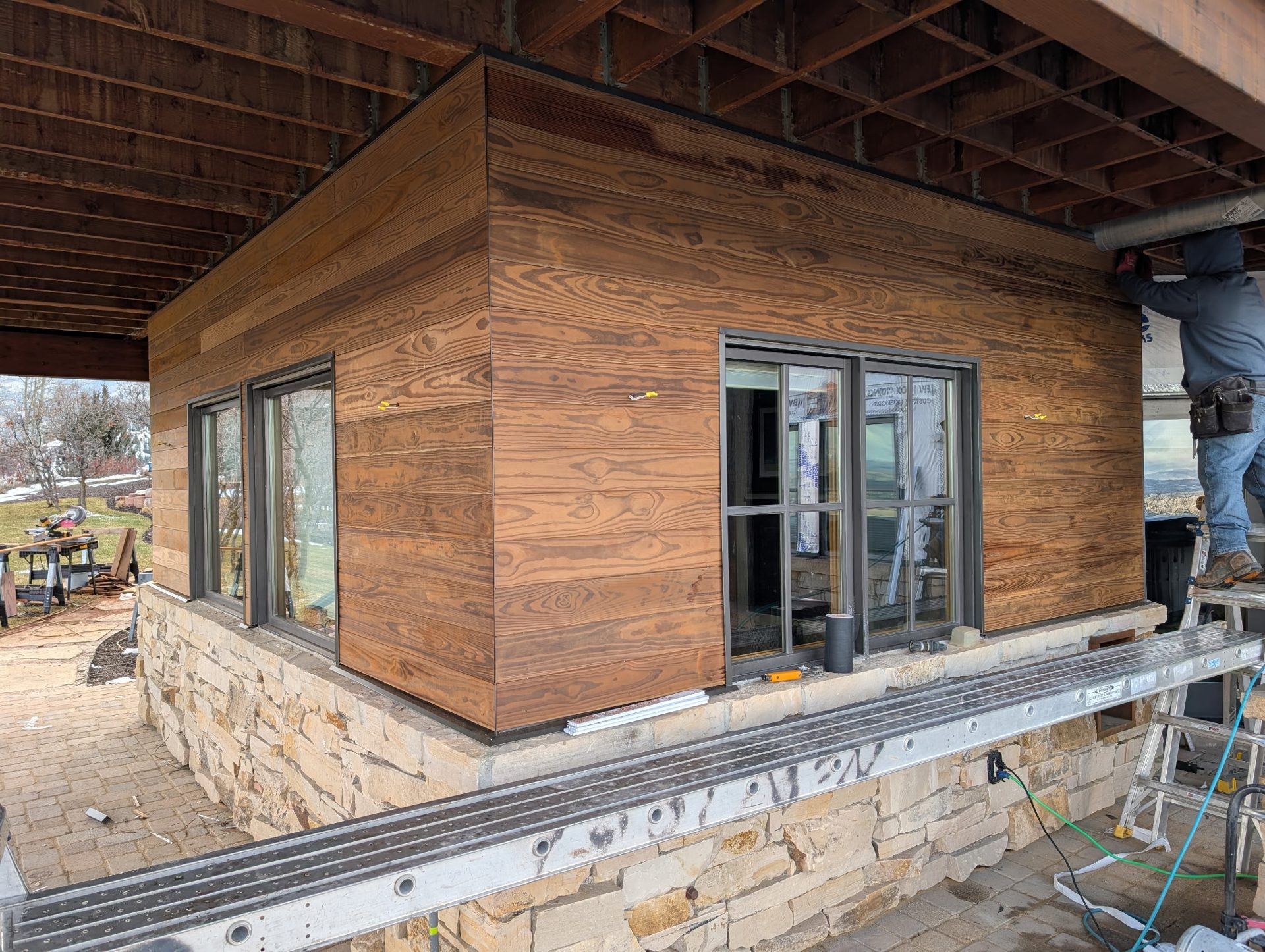 Red Rooster crew installing wood siding and stone on a Utah home