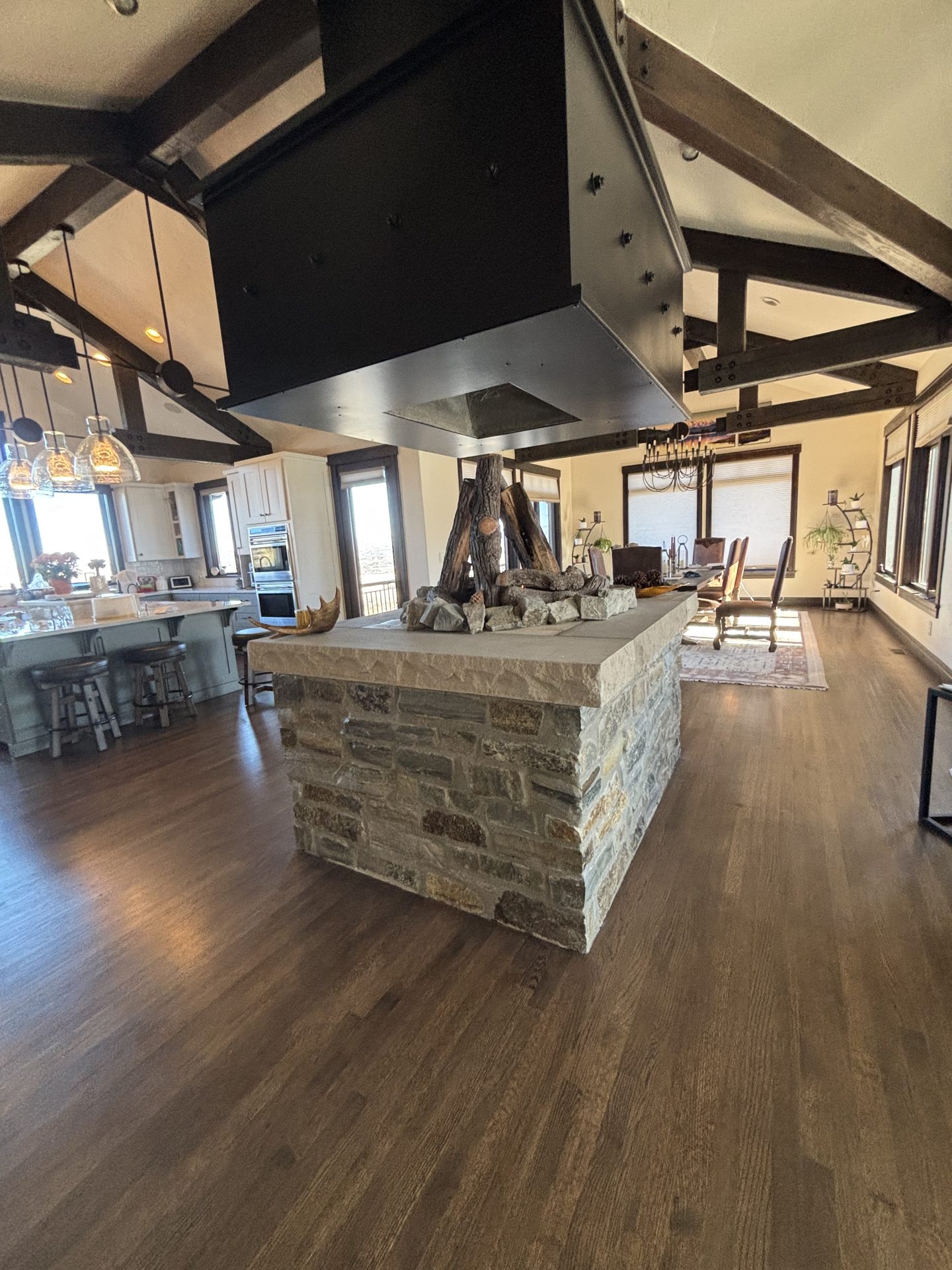 Stone kitchen island with vaulted beam ceiling