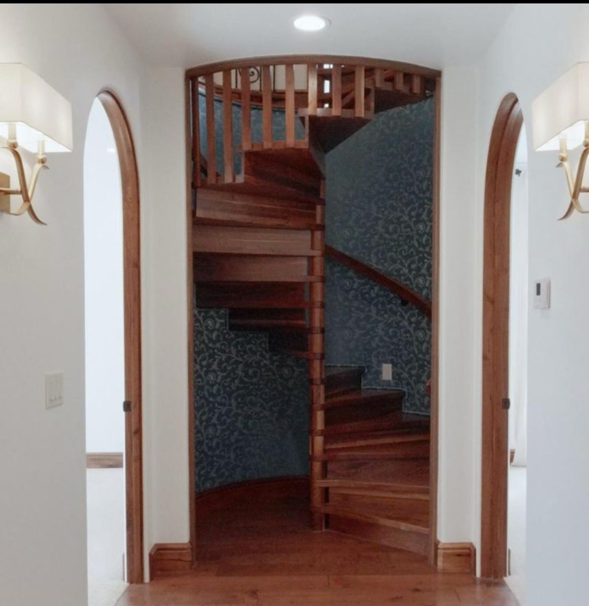Custom spiral staircase with arched doorway