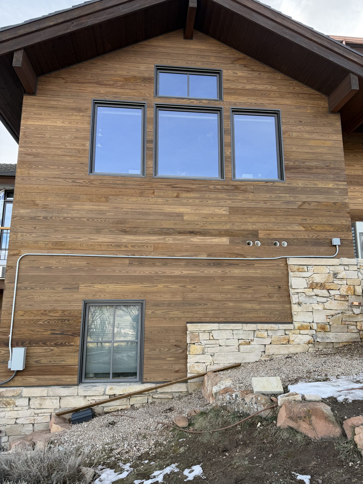 Exterior wood siding with stone accents
