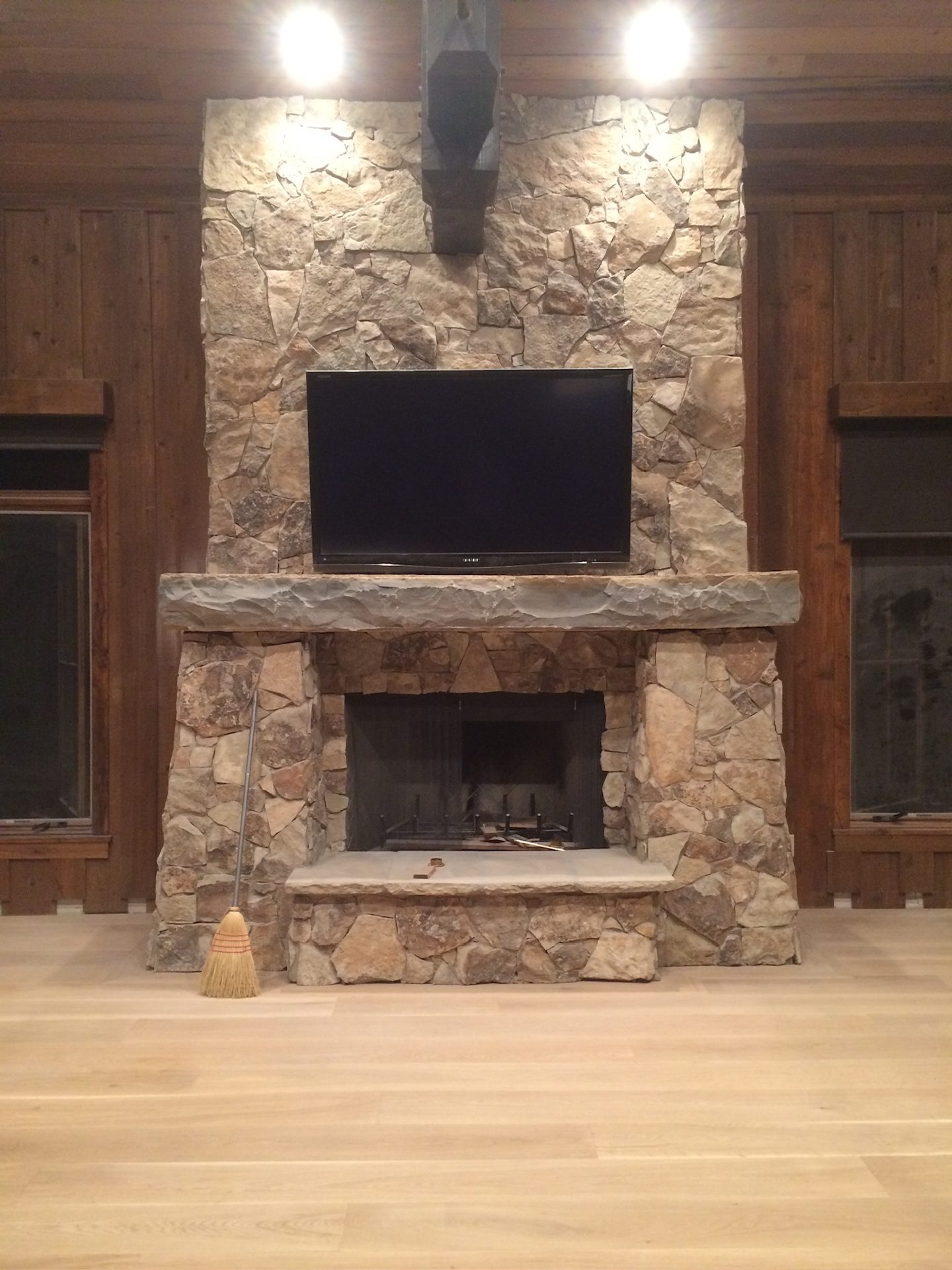 Stone fireplace with wood surround